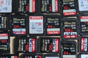 A table filled with numerous Sandisk SD cards, all organized and ready for use in various devices.