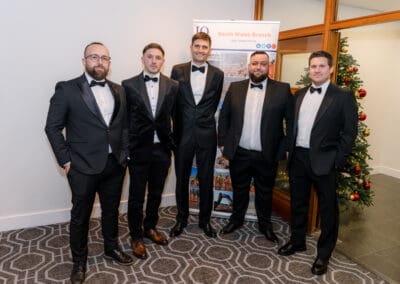 Group of men in black tie posing for the camera