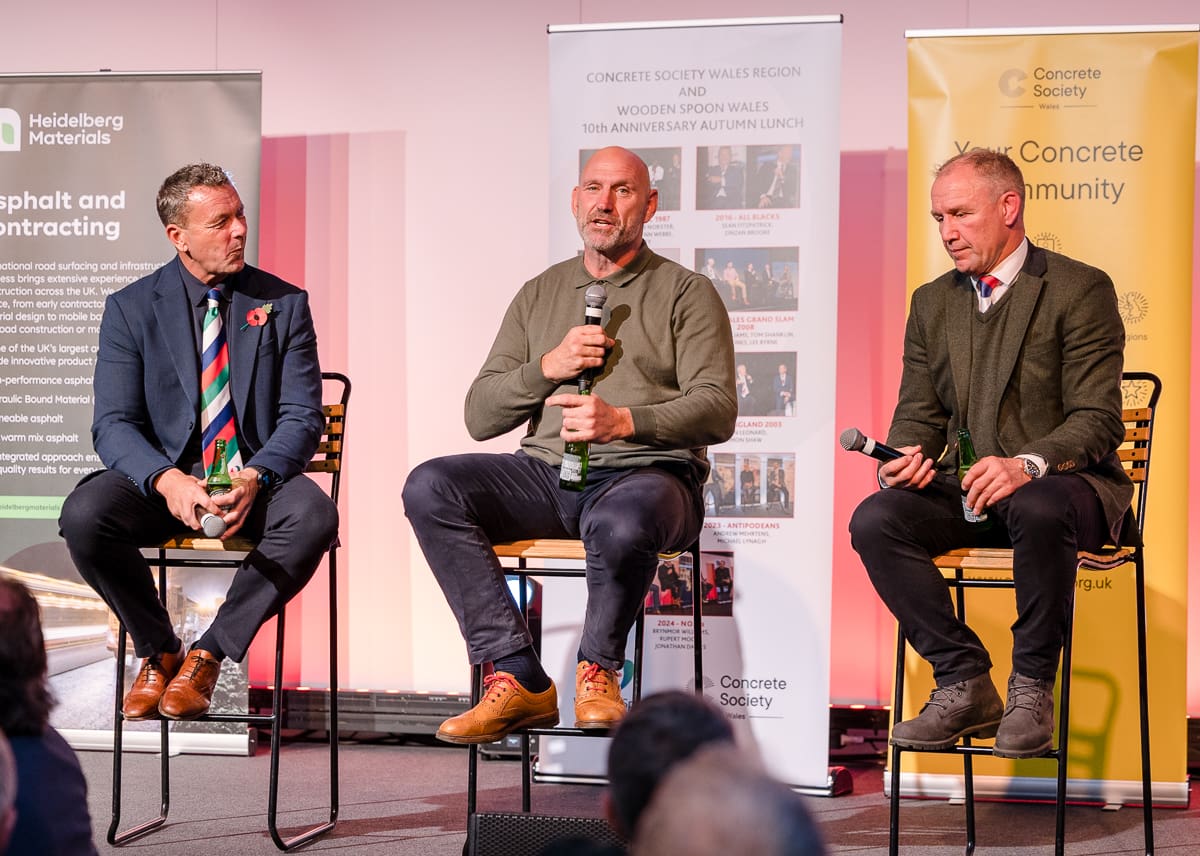 Laurence DeLallio sat with Sean Holley and another English Rugby Player sat on stools speaking at a corporate event